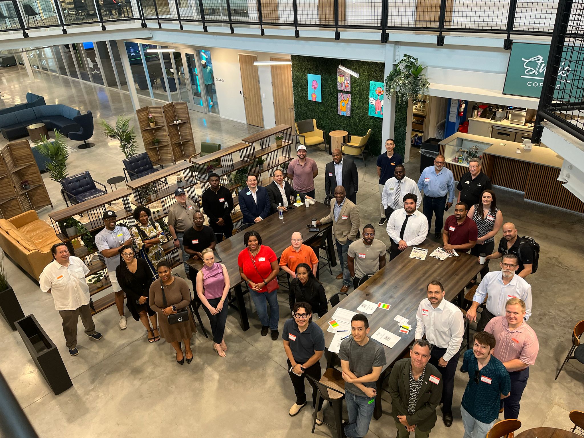 HTown Handshakes networking event in Houston — dozens of small business owners gathered around a long communal table