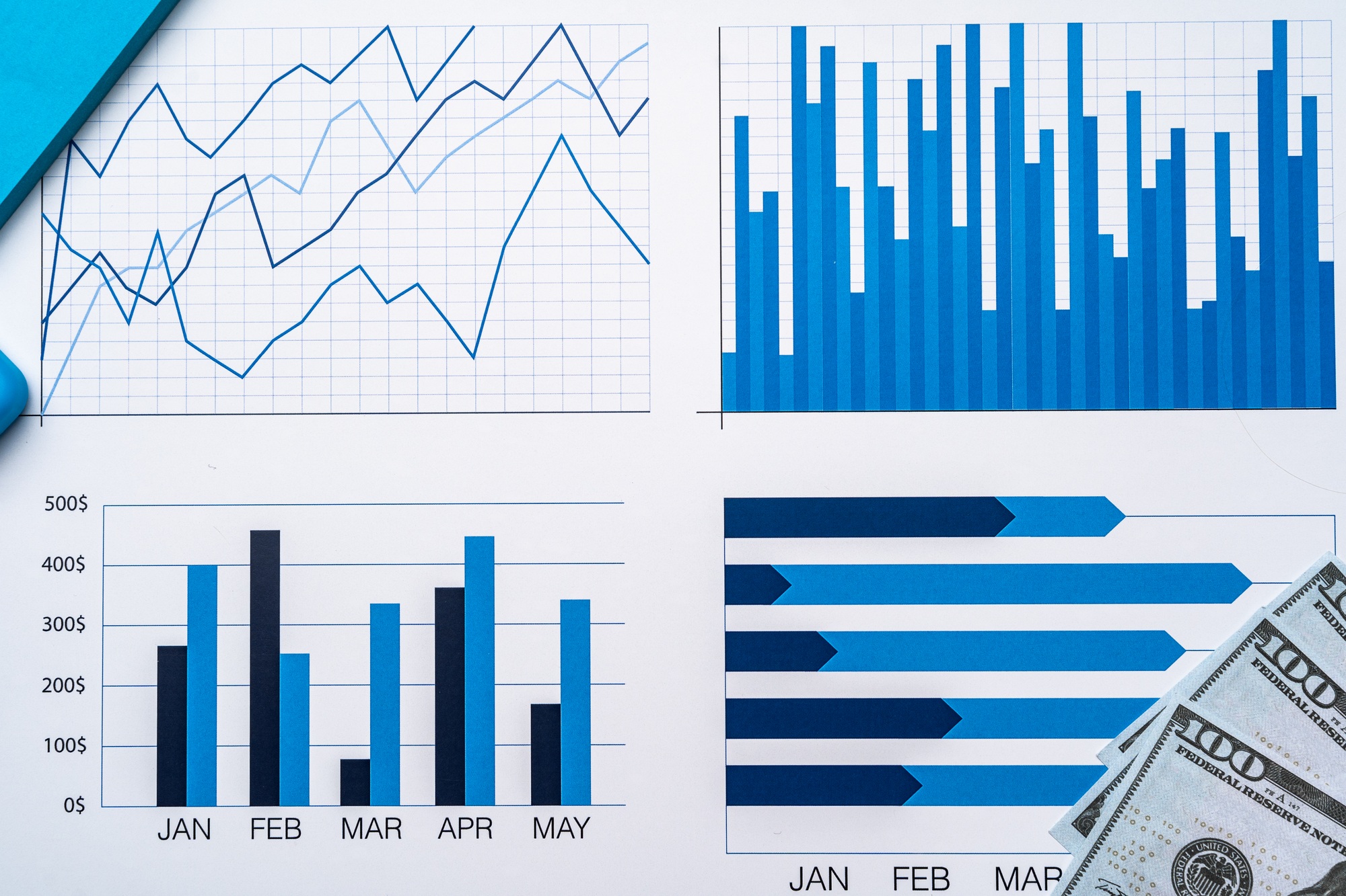 Financial paper with charts and diagrams on gray table